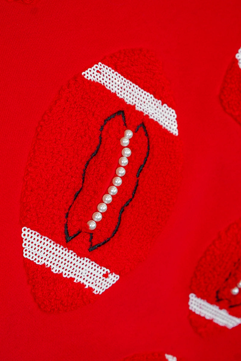 queen of sparkles fuzzy red football shorts