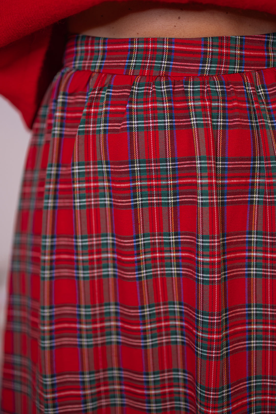 Women's red and green plaid midi skirt by Entro showing up close look at plaid pattern