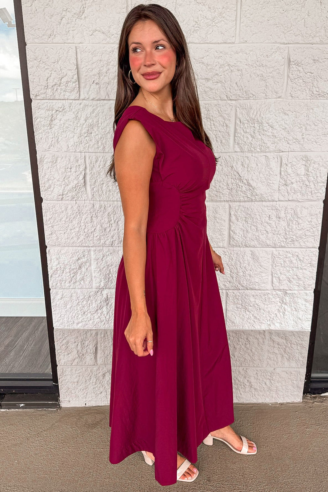 solid wine red sleeveless midi dress with ruched side panels at waist