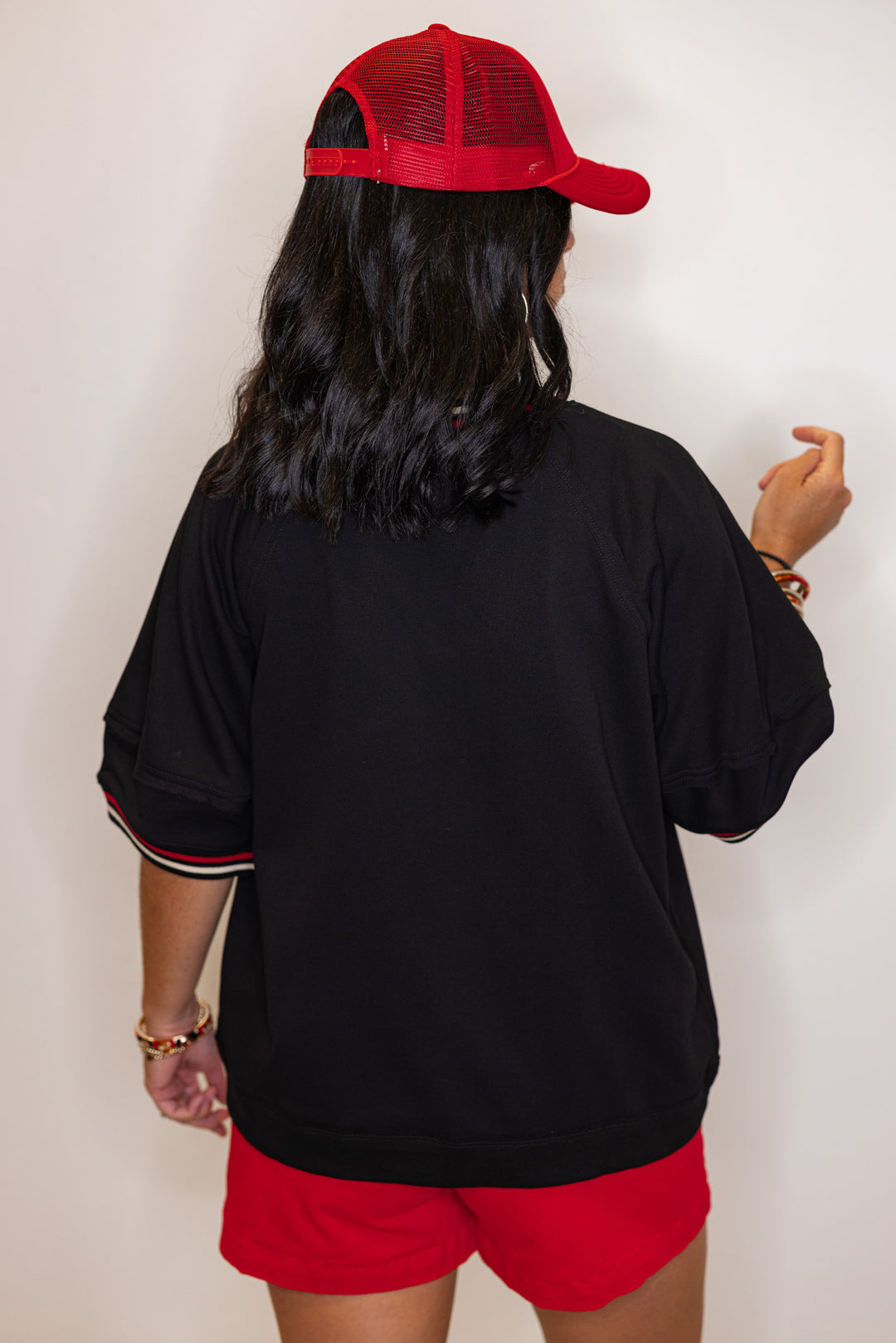 Women's black french terry knit top with cream and red striped trim by Entro showing up close back view