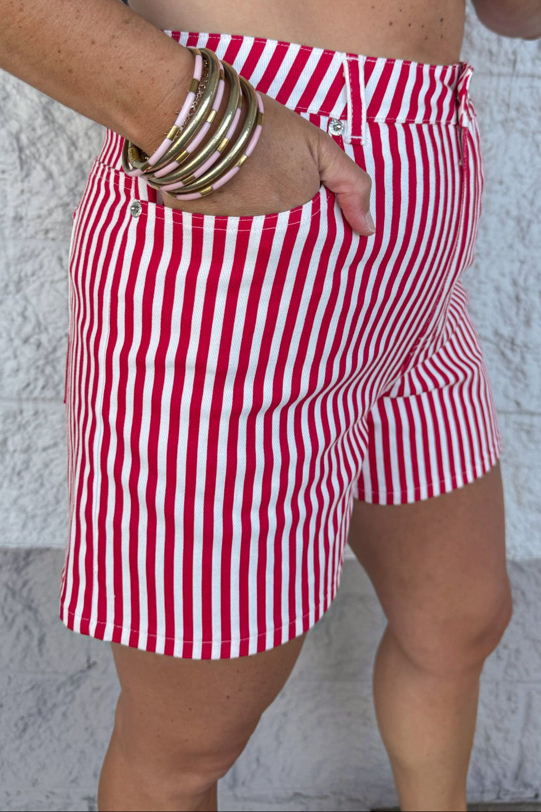 red and cream vertical striped print five pocket style twill shorts