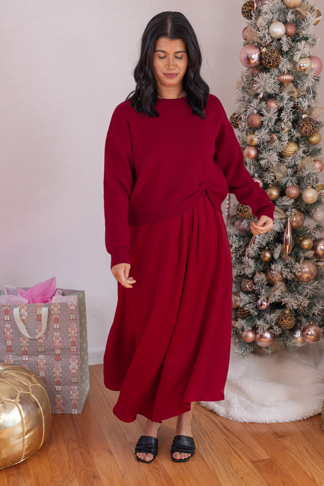 Women's burgundy knit cropped sweater top with knotted detail at the hem by Jodifl shown with skirt