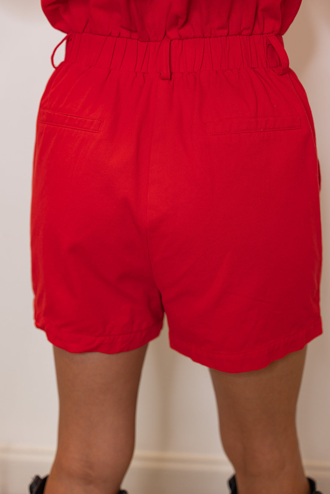 Washed red denim button front sleeveless cargo romperby &merci showing up close back view