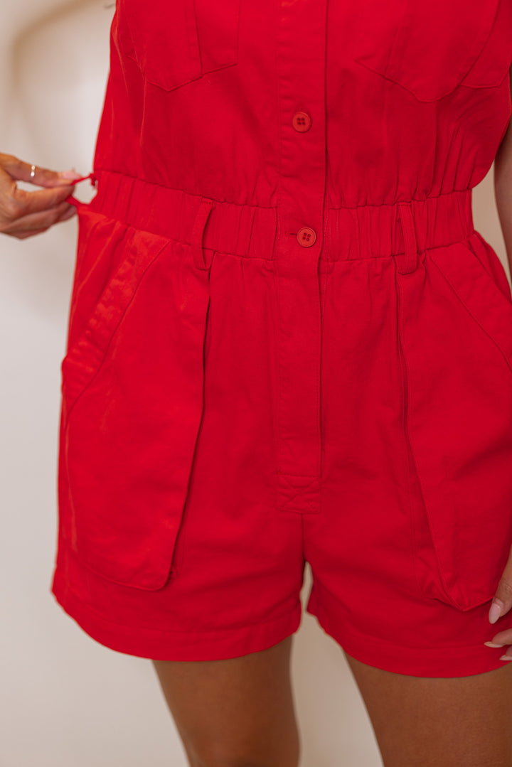 Washed red denim button front sleeveless cargo romper by &merci showing belt loops