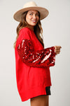 Fantastic Fawn Red terry knit pullover with red sequin sleeves