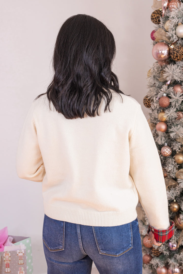 Women's cream button front sweater knit cardigan with contrasting red plaid trim by Entro showing up close back view