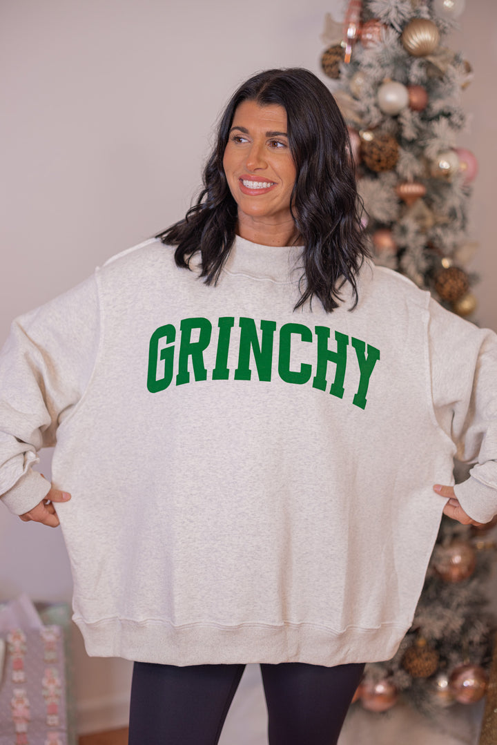 Women's reversible sweatshirt with "Grinchy" on grey or "Naughty" on white by BucketList showing oversized fit