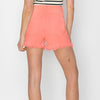 risen coral colored denim cut off shorts with raw hem line
