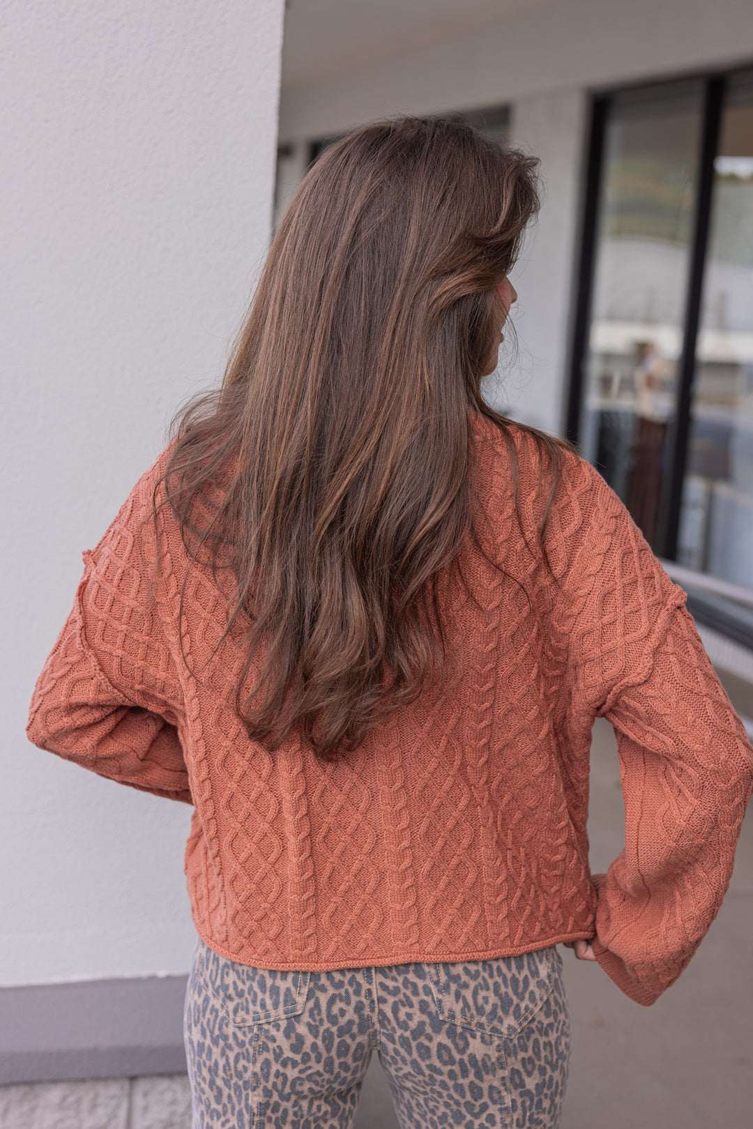 Women's terra cotta cable knit sweater cardigan by Entro showing up close back view