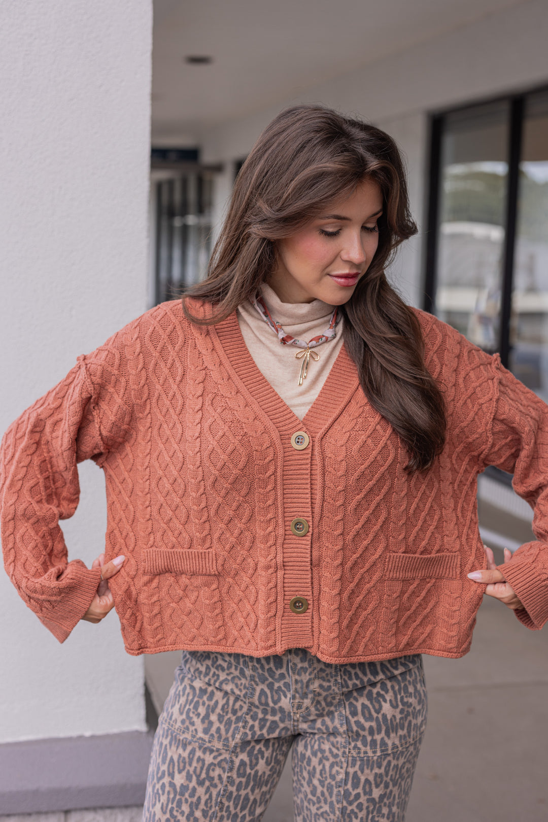 Women's terra cotta cable knit sweater cardigan by Entro showing relaxed fit