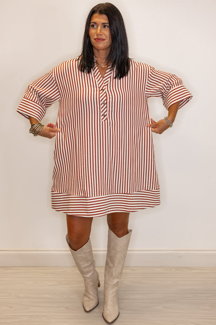 showing fit of Woman's relaxed fit  rust and ivory striped dress