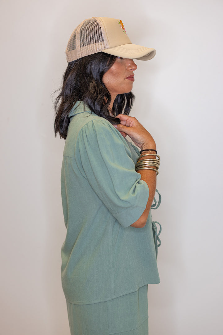 Women's sage green linen bow tie top and elastic waist wide leg pants set by Jodifl showing up close side view of top