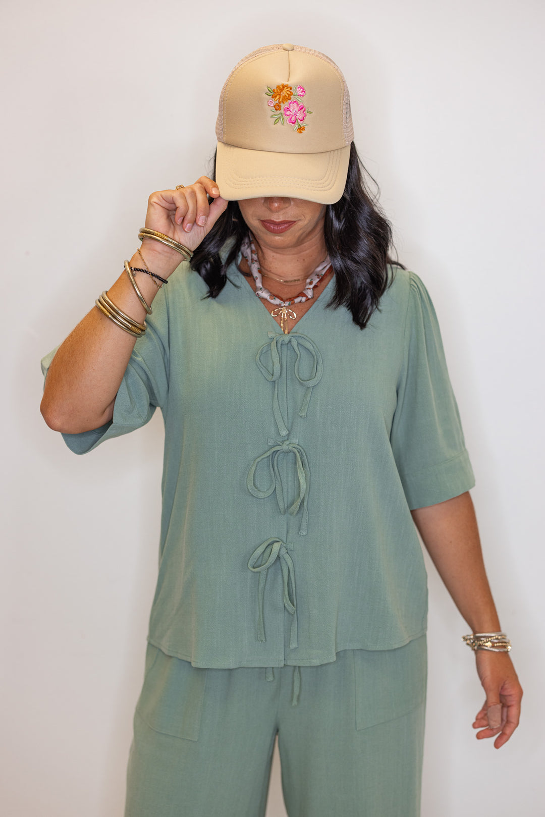 Women's sage green linen bow tie top and elastic waist wide leg pants set by Jodifl showing up close front view of top