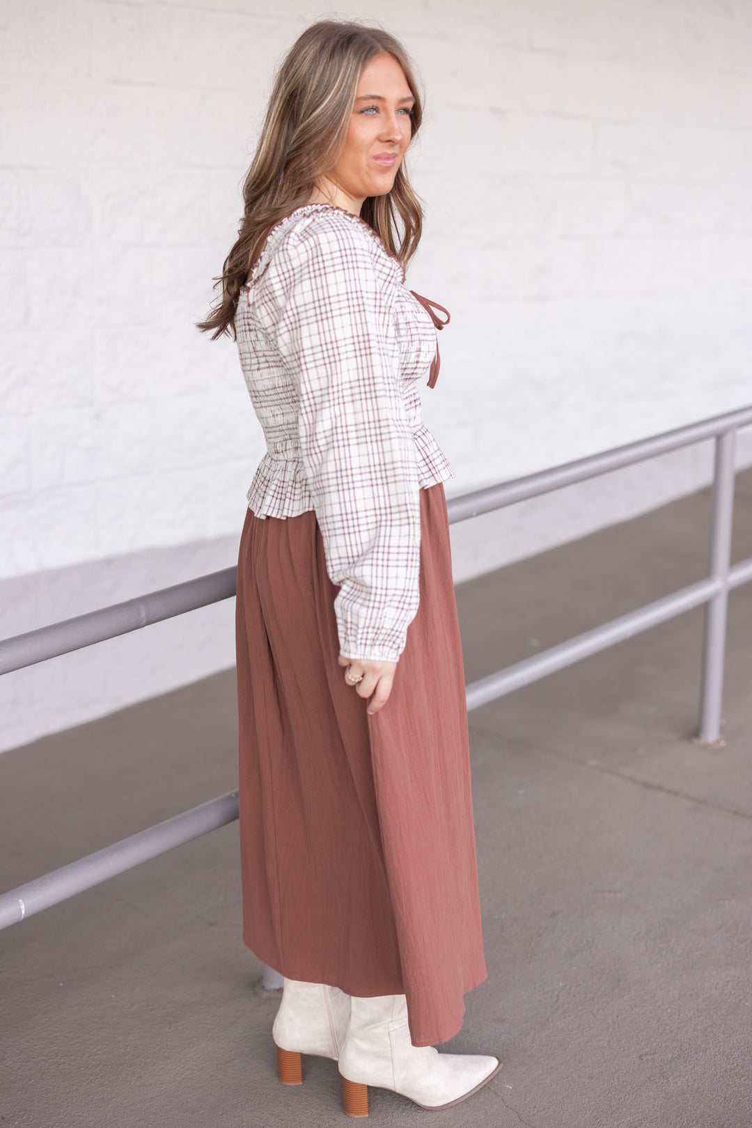 Women's ruffle detailed midi dress with smocked plaid top and solid brown skirt by In February showing side view