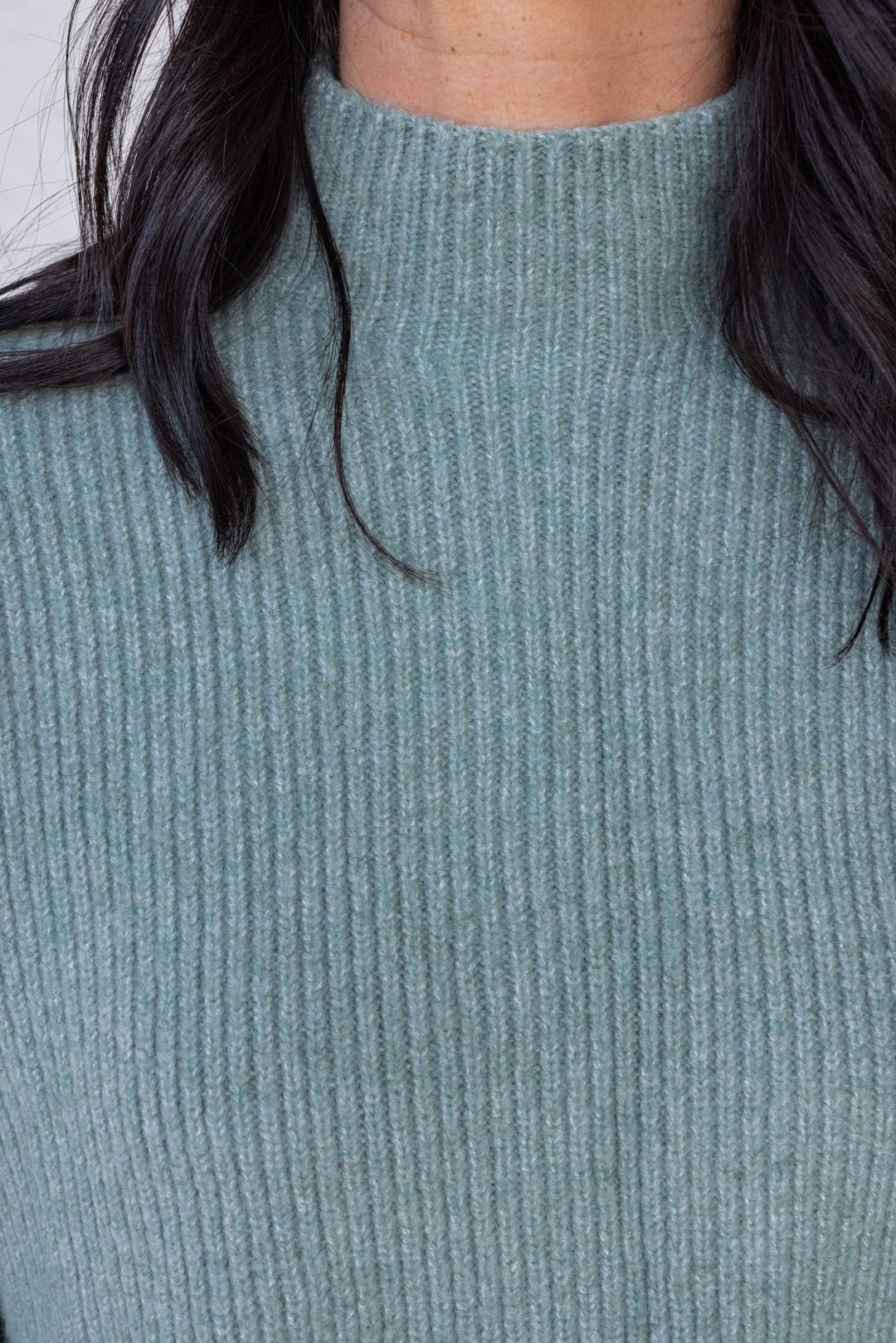Women's pistachio green ribbed knit sweater by Wishlist showing mock neckline
