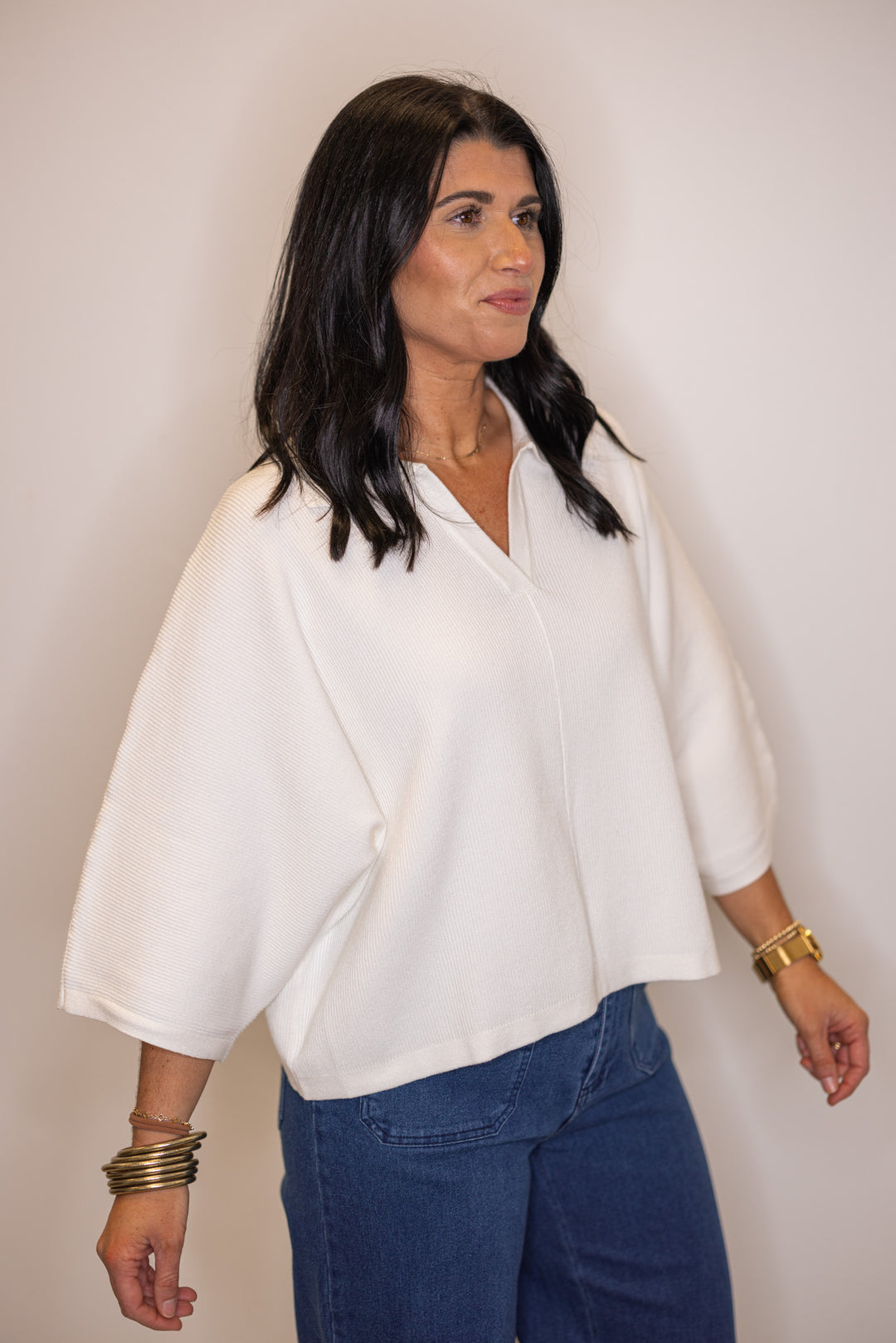 Women's off white ribbed knit top with a collar by Entro showing wide 3/4 length sleeve