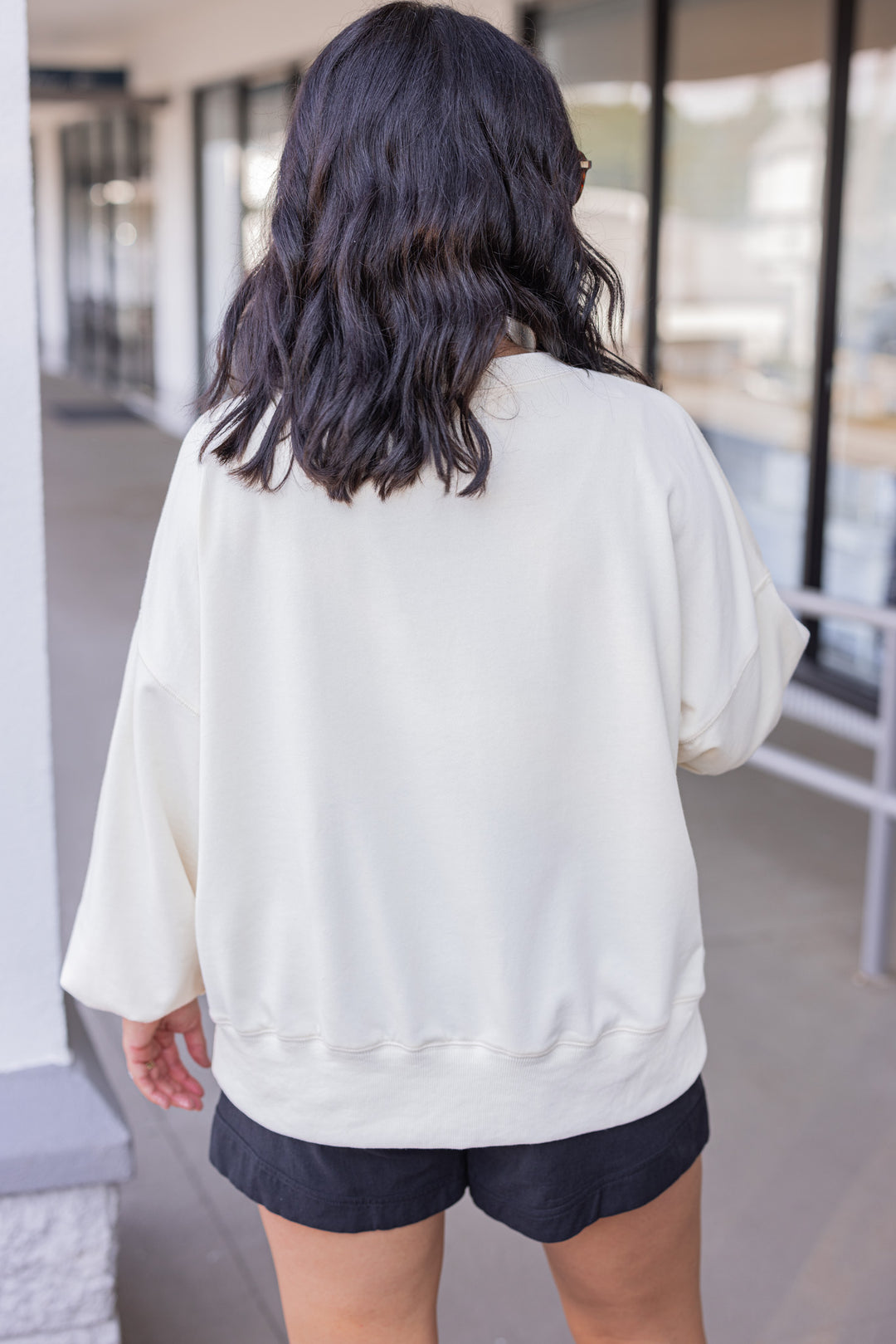 Women's cream sweatshirt with "Spooky" in lace ghosts and black checkered print by Peach Love California showing up close back view