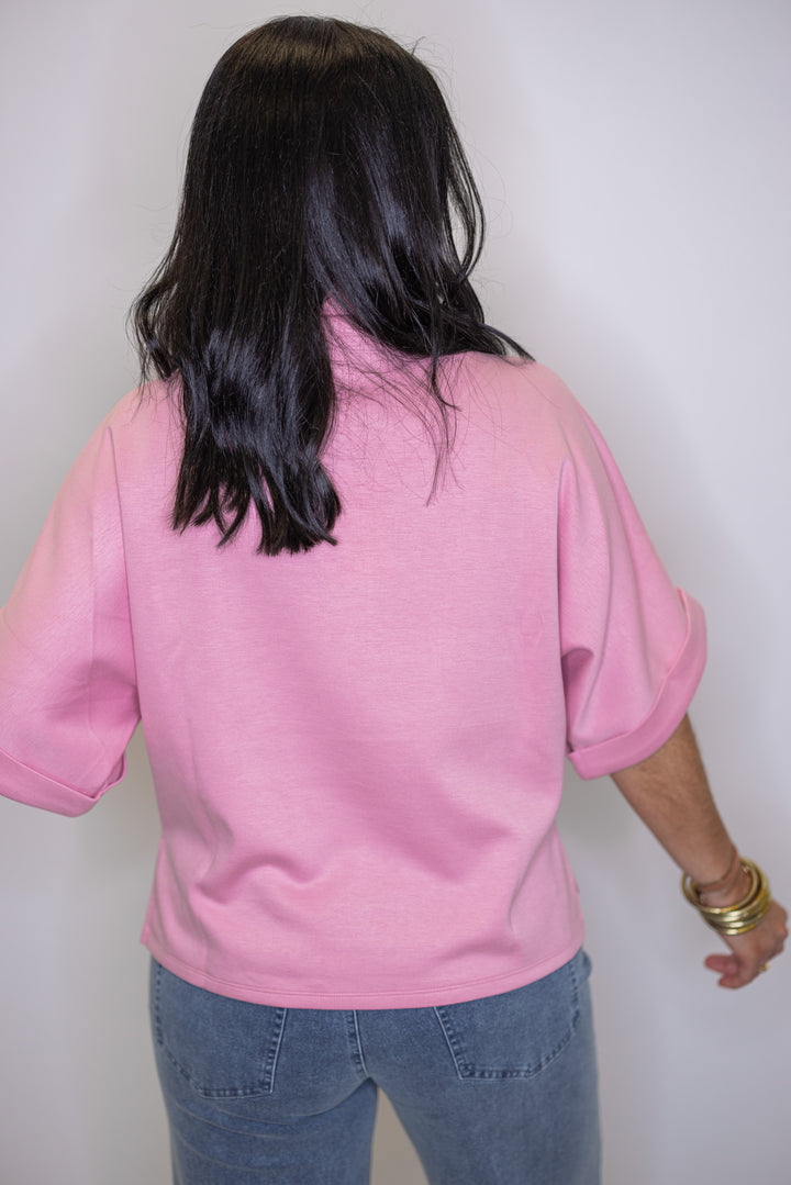Women's light pink scuba knit top by Entro  showing rolled cuffs on dolman sleeves