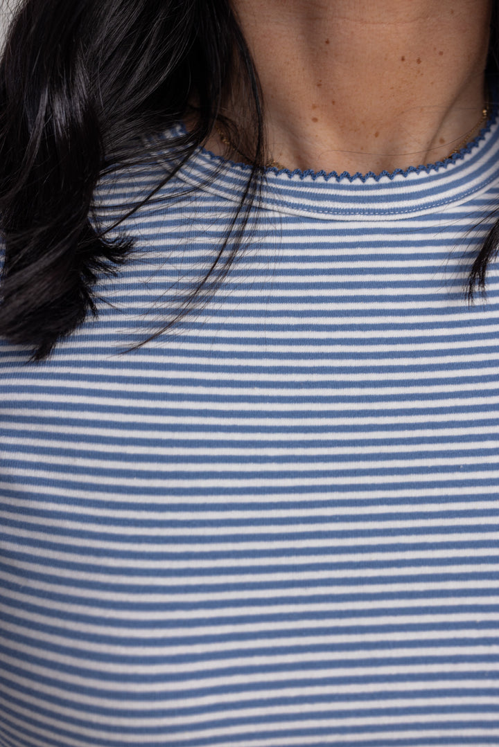 Women's blue and white striped knit long sleeve top by Wishlist showing scalloped trim on crew neckline