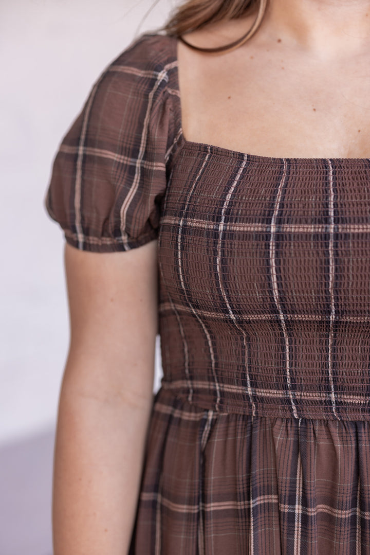 Women's brown plaid midi dress with smocked bodice by Blu Pepper showing smocked bodice