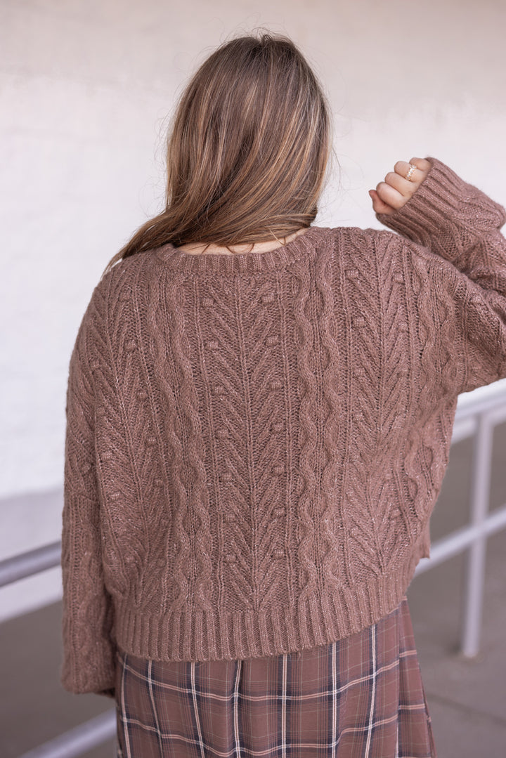 Women's mocha brown cable knit sweater cardigan with black bow tie closure by Blu Pepper showing up close back view