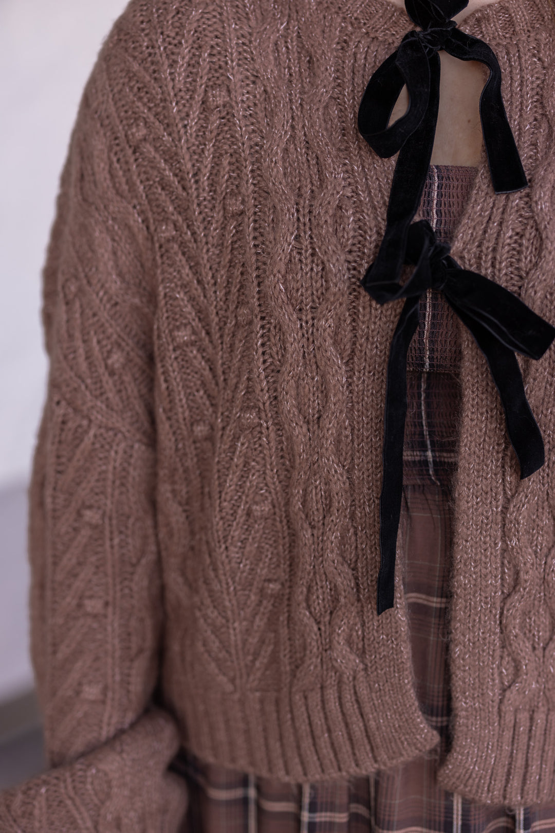 Women's mocha brown cable knit sweater cardigan by Blu Pepper showing black bow tie closures