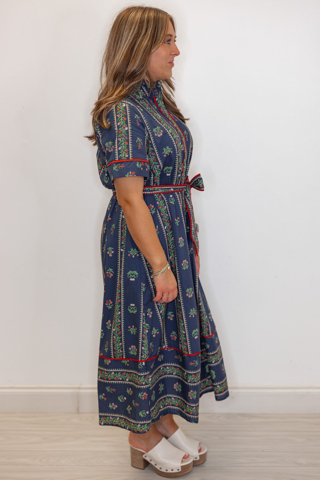 Women's navy blue button front midi dress with floral trellis print and red trim by Entro showing full side view