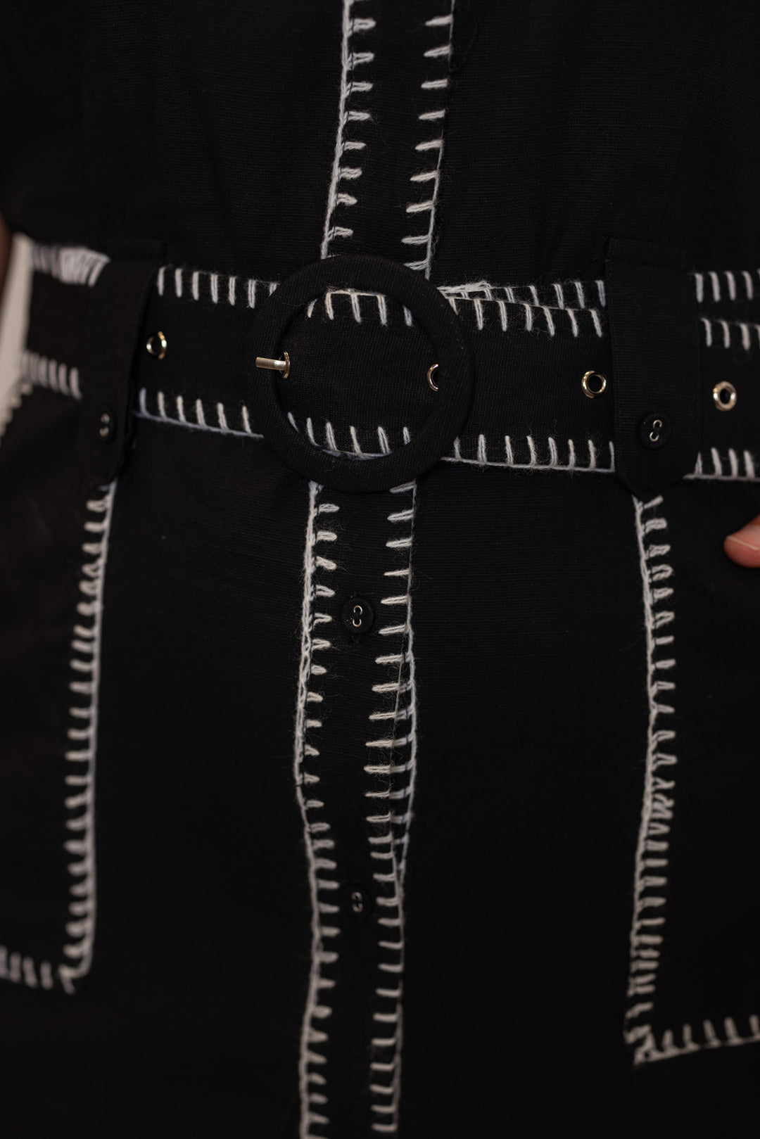 Black button down dress with belted waist and cream stitching trim by Entro showing removable belt and cream stitch details