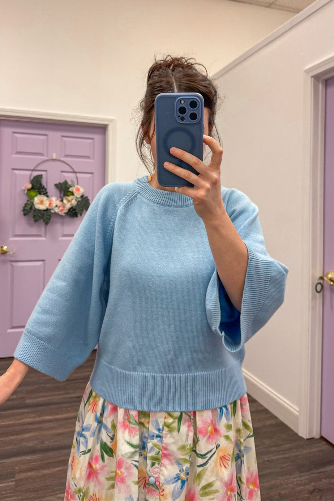 Women's light blue sweater with accent stitching details by Entro showing 3/4 length wide sleeves