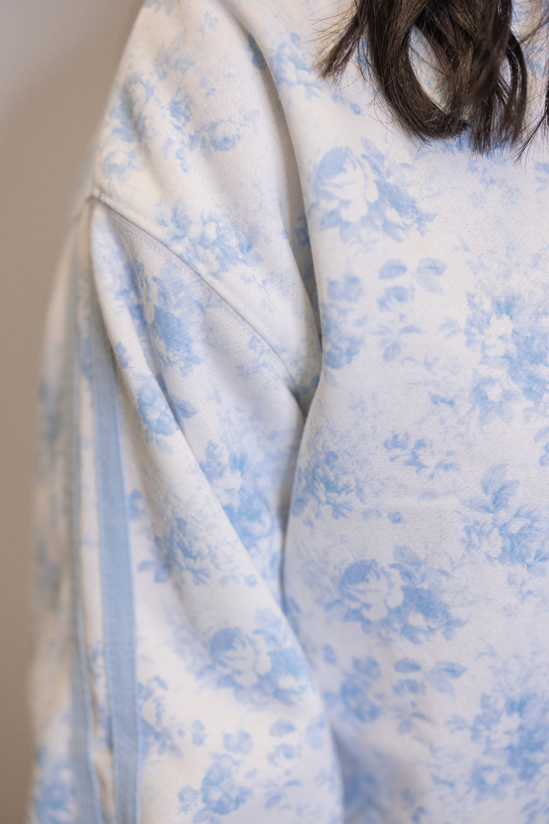 Women's cream french terry knit pullover sweatshirt with light blue floral print showing close look at floral print