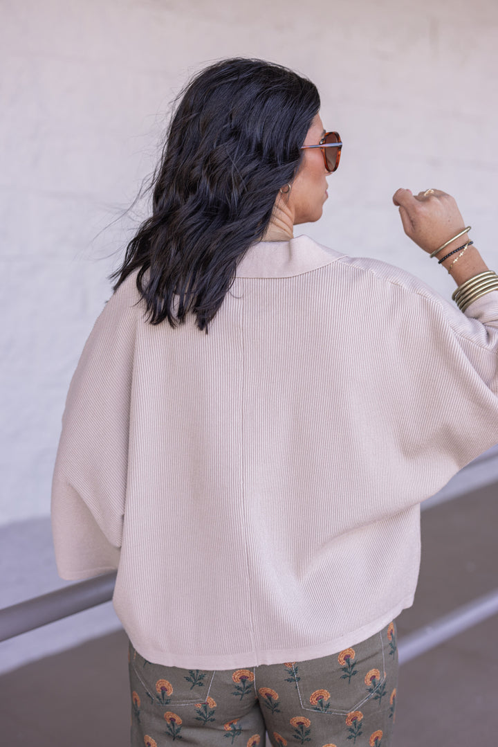 Women's light beige ribbed knit top with a collar by Entro showing back view