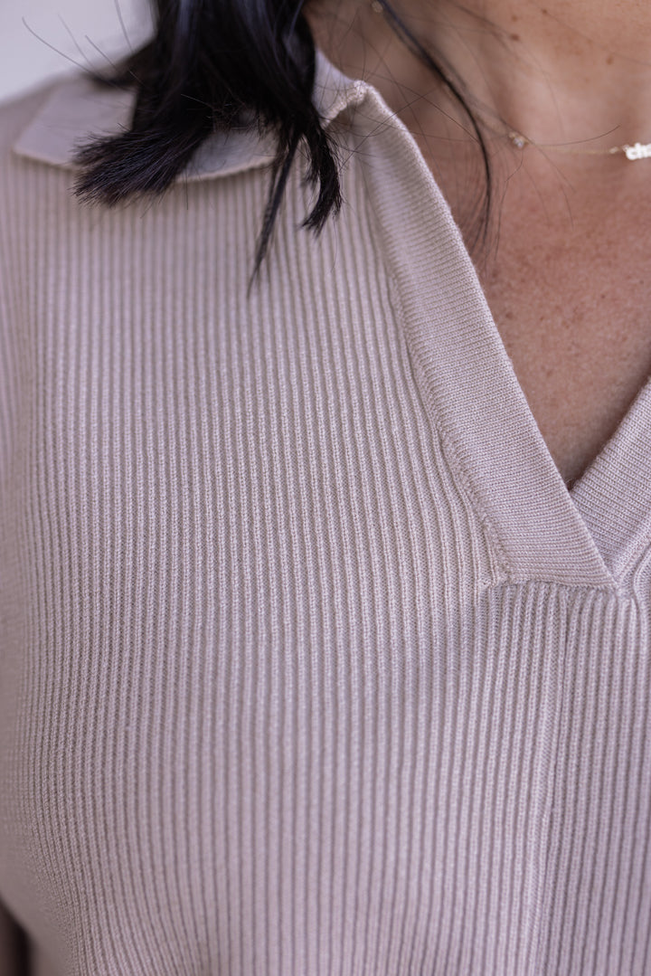 Women's light beige ribbed knit top with a collar by Entro showing ribbed knit fabric