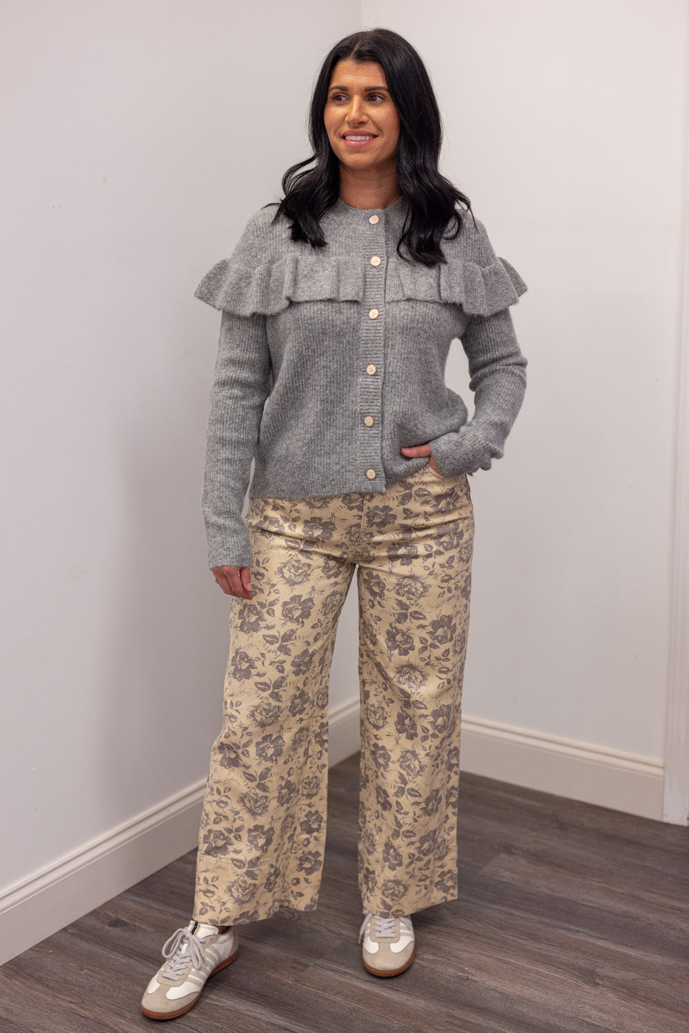 Women's grey knit sweater with a ruffle across the front chest and back shoulders by Wishlist showing full front view