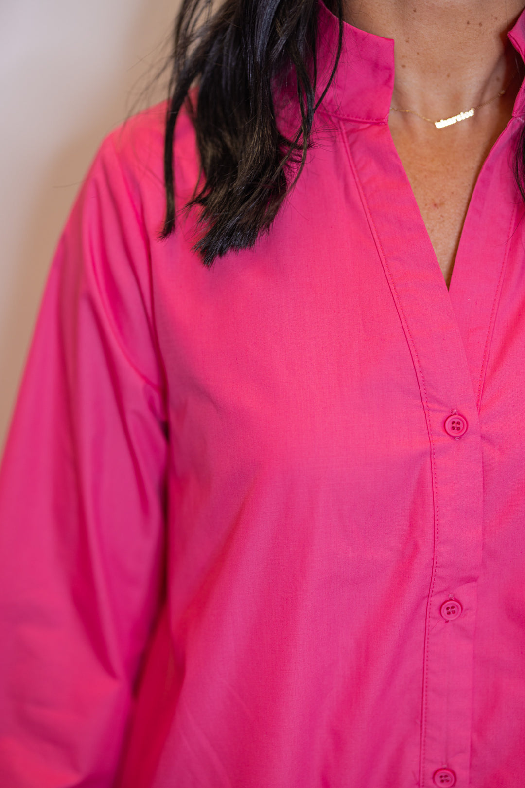 Women's pink midi dress by Entro showing button front closures