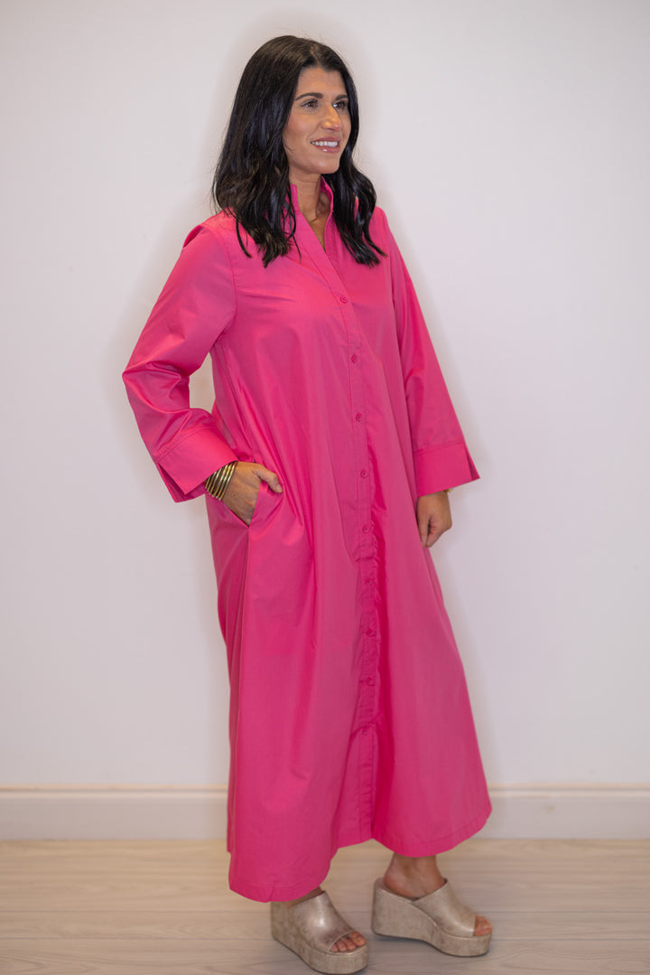 Women's pink button front midi dress by Entro showing side pockets