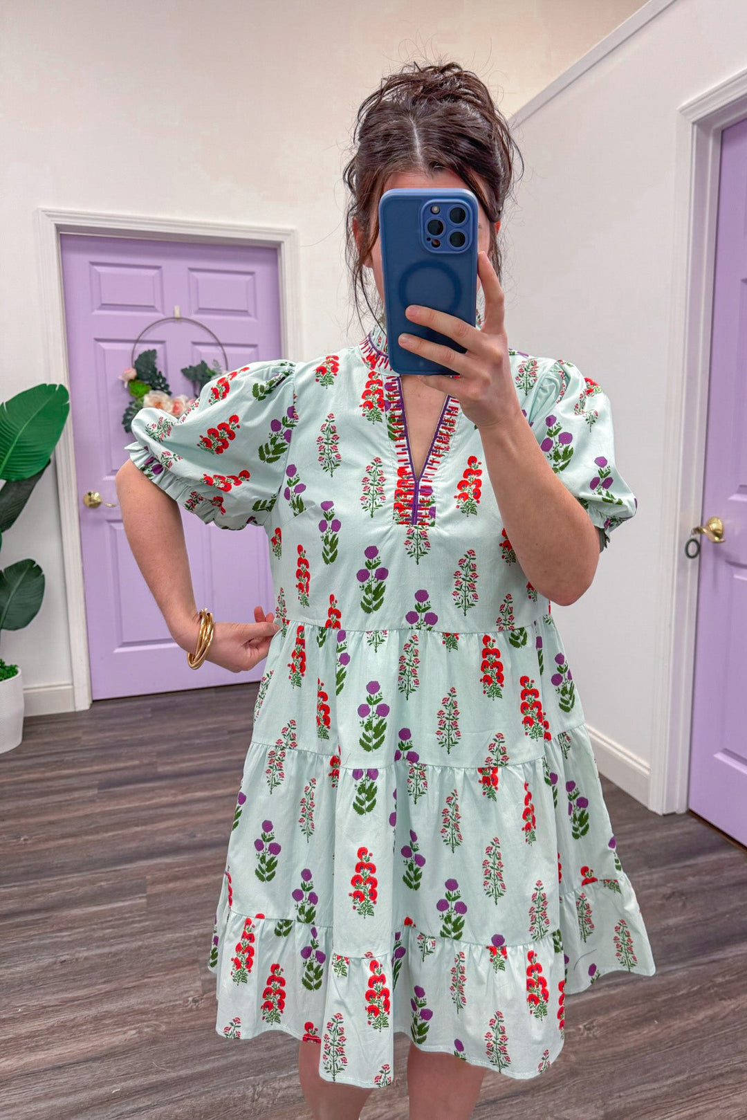 Women's light mint poplin dress with purple and red florals and embroidery trim showing true to size fit