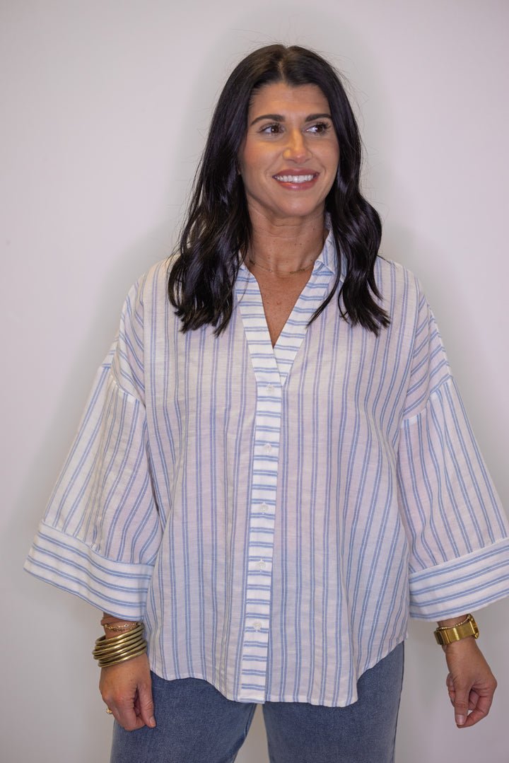 Women's light blue and cream striped button down top