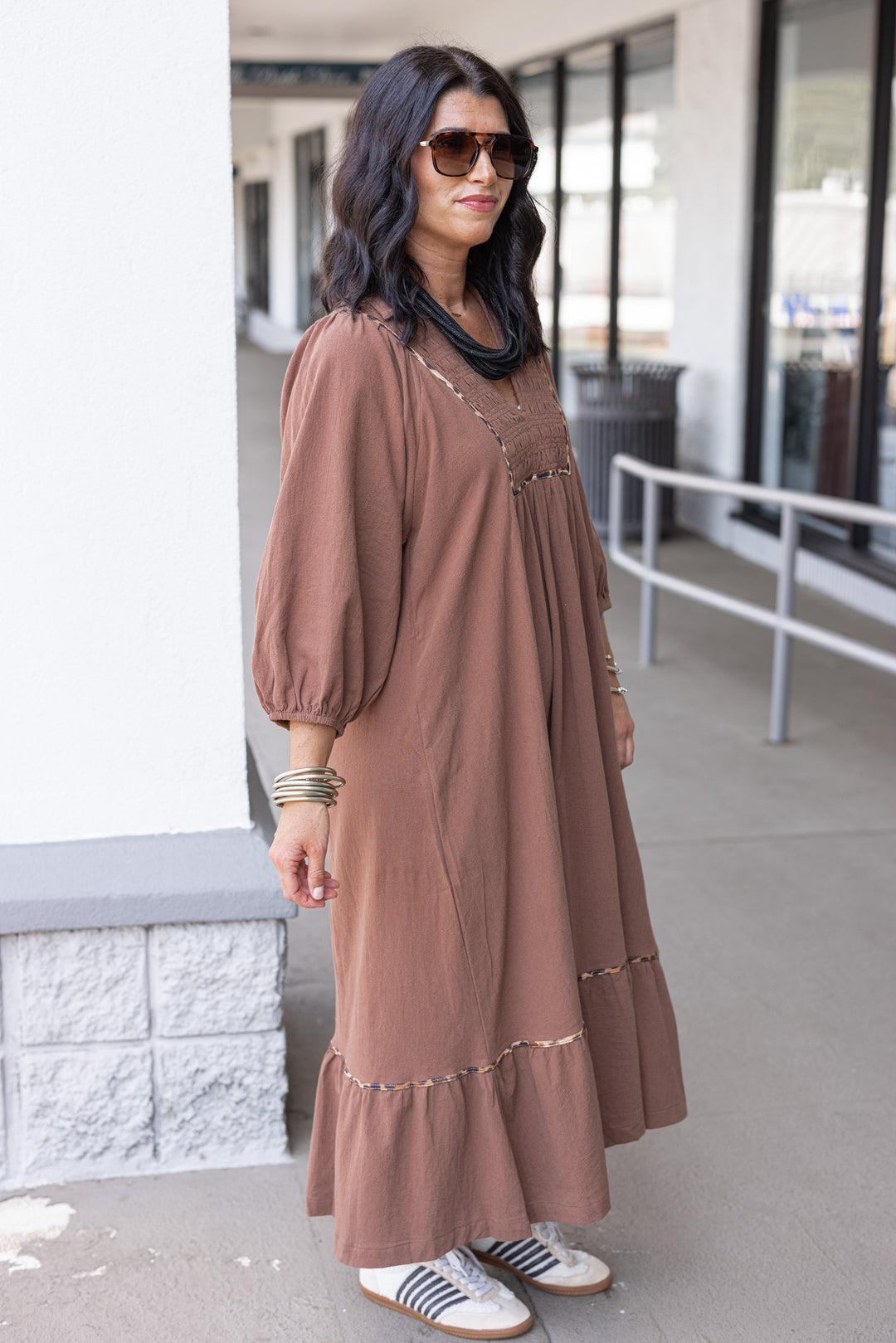 Women's brown midi dress with smocked bodice and leopard print trim by Umgee showing slight side view
