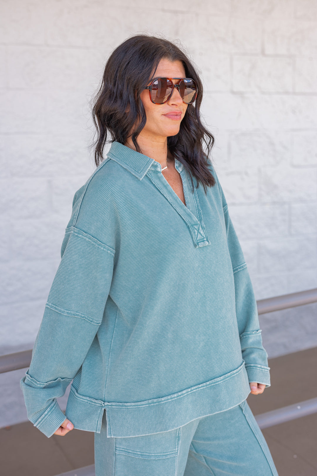 Women's washed teal ribbed knit top by Easel showing side view