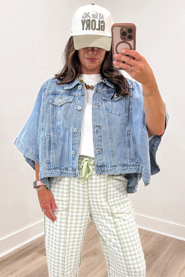 solid washed blue denim collared neckline button front short drape sleeve poncho style jacket