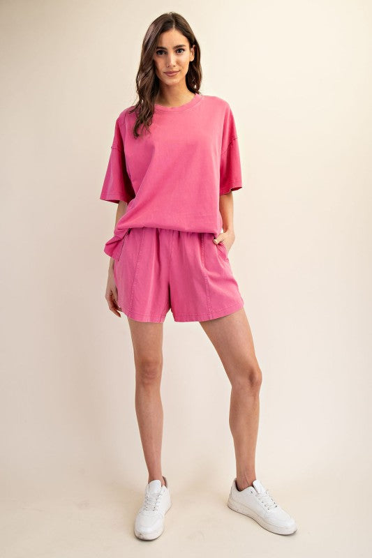 Women's elastic waist knit shorts in mineral washed french pink by Rae Mode showing full front view