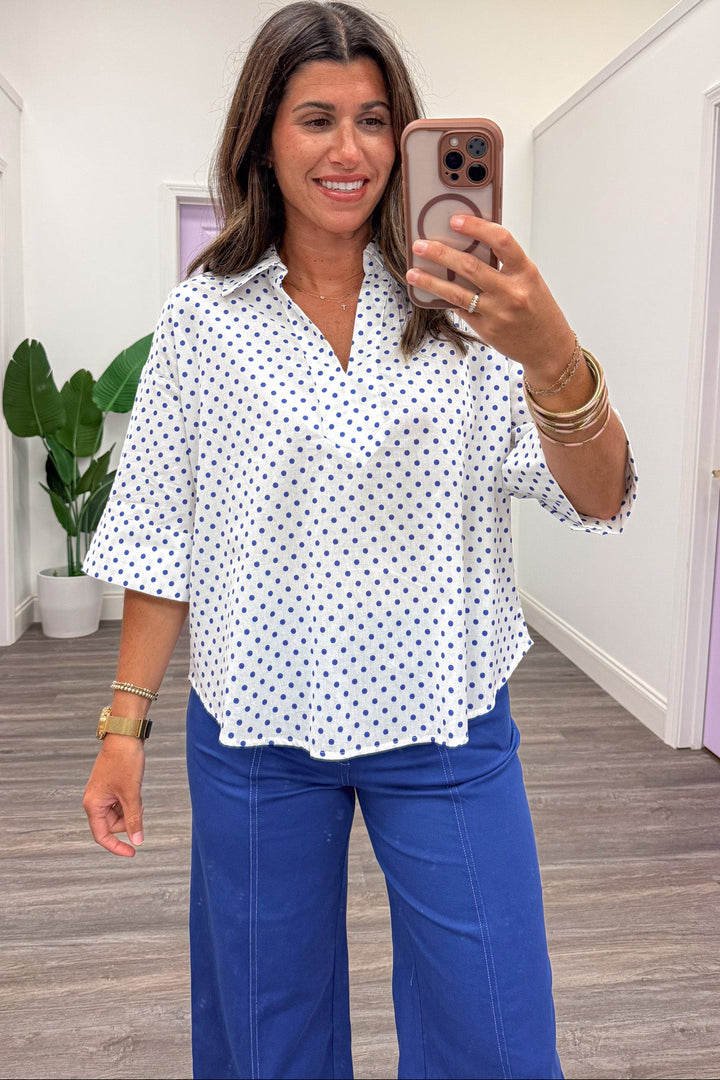 off white with small blue polka dot print collared v neckline cotton top