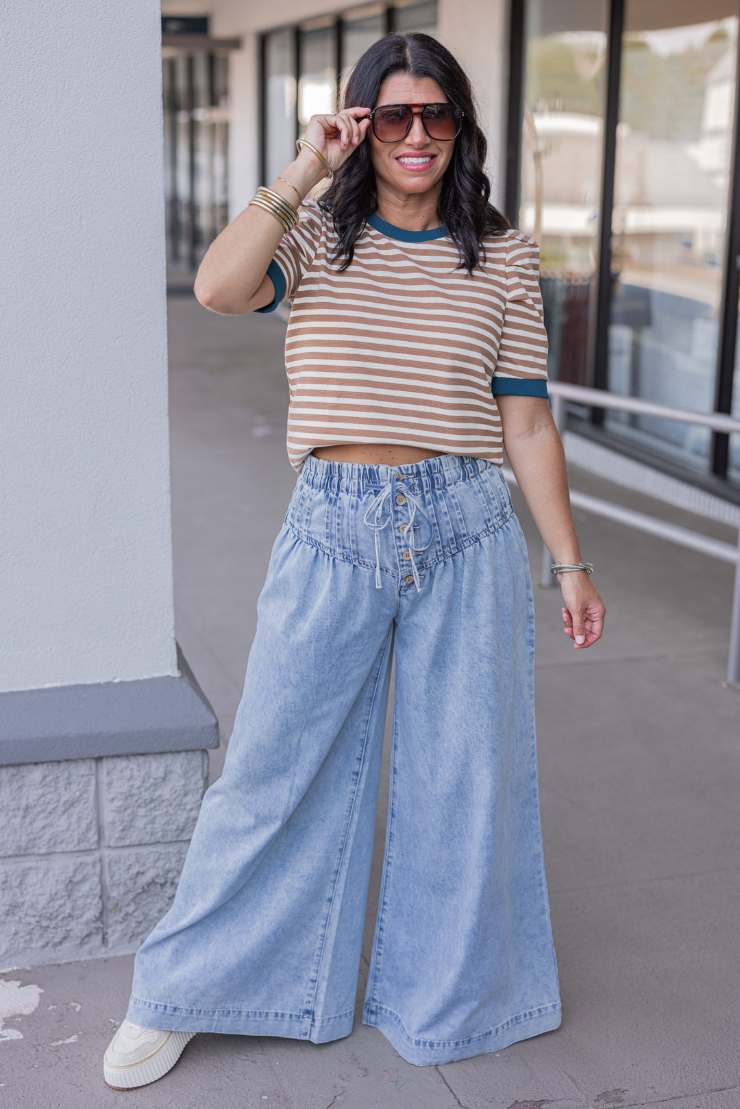 Palazzo style wide leg light blue washed denim pants with button fly by ee:some showing full front view