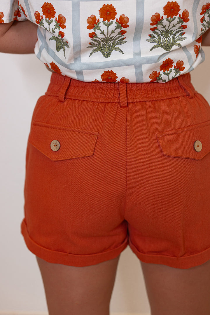 Women's rust twill denim pintuck shorts by Entro showing back view
