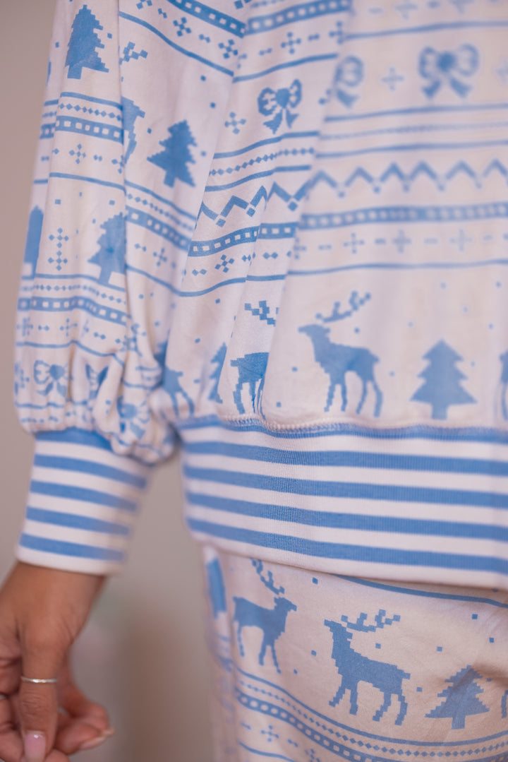 Women's white and light blue Christmas Winter print fleece pajama top by Peach Love California showing ribbed cuff sleeves and ribbed bottom hem