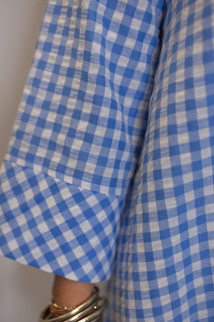 Women's blue and white gingham midi dress with hidden button front by Entro showing wide cuffed 3/4 length sleeves