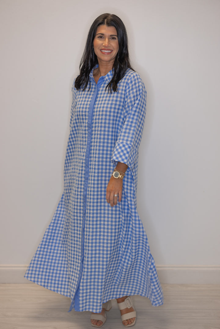 Women's blue and white gingham midi dress with hidden button front by Entro showing flowy skirt
