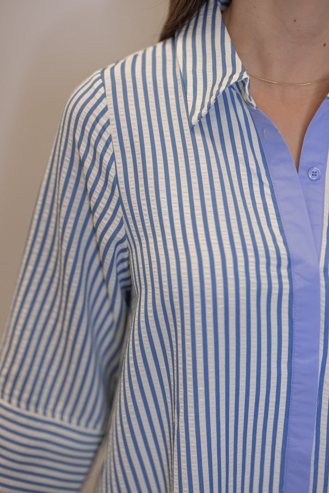 Women's striped blue maxi dress by Entro showing collared neckline and hidden button details