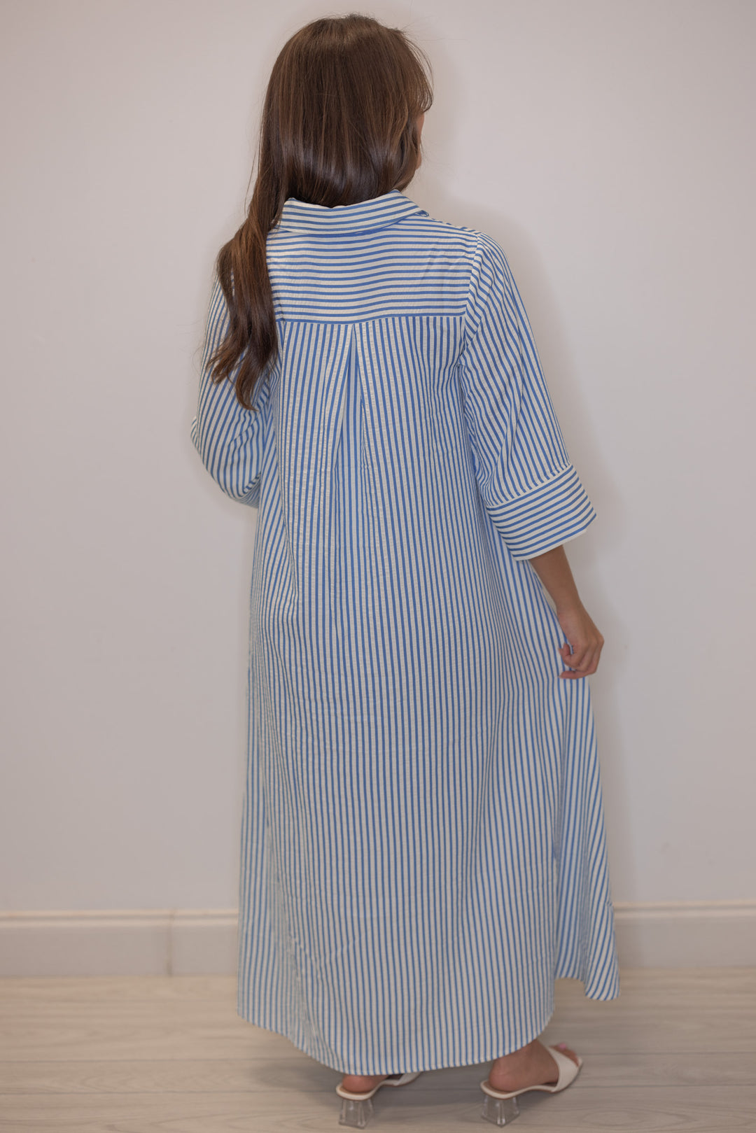 Women's striped blue maxi dress by Entro showing pleated detail in back