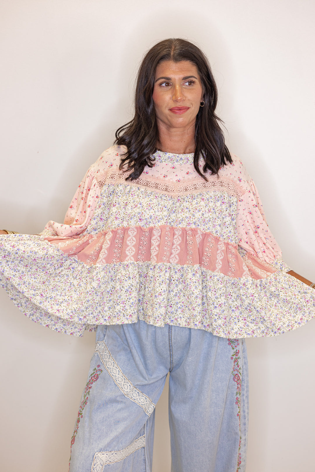 Women's pink and ivory floral patchwork top with embroidery and eyelet details by POL showing relaxed silhouette 